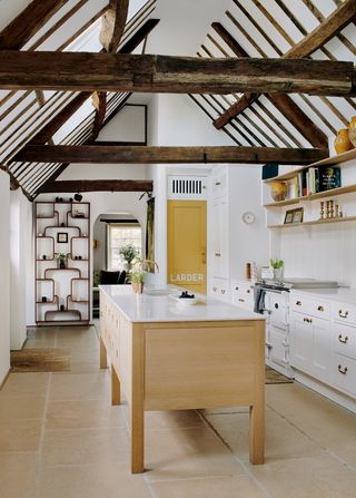 A kitchen in a Cotswolds home restored by Catherine Chichester cupboards drawn up by the artist John Simpson are teamed...