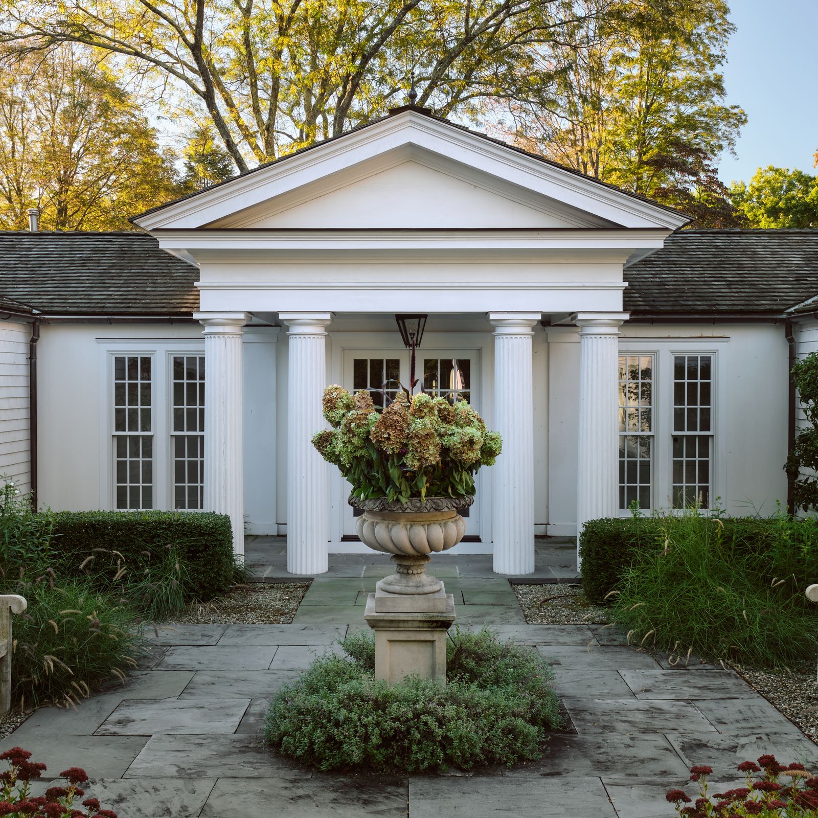 A Greek Revival house in a sleepy New York suburb with theatrical, comfortable interiors