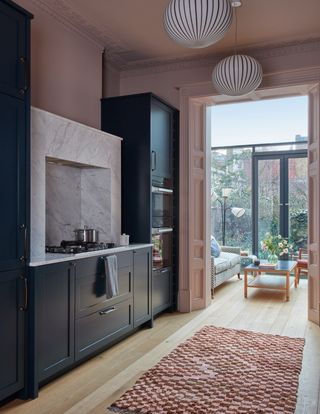 The kitchen in a Kensington house by Kate Guinness designed and made in collaboration with 202 Design shows how colour...