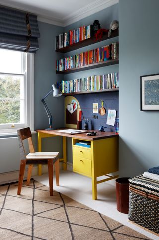 Image may contain Lamp Chair Furniture Table Desk Home Decor Rug Art Painting Bookcase Cup Clothing and Glove