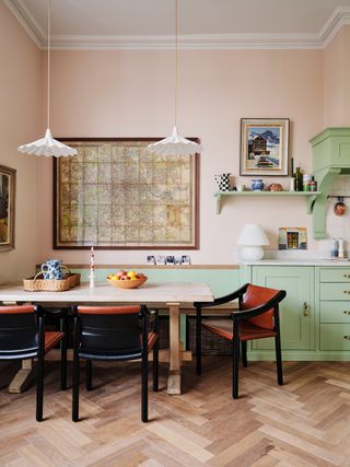 Red and black dining chairs form a bold counterpoint to the pretty green and pink scheme in Daisy SimsHilditch's Notting...