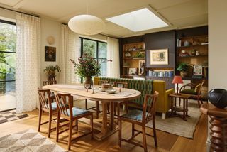 Image may contain Architecture Building Dining Room Dining Table Furniture Indoors Room Table Lamp and Plant