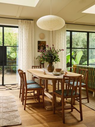 Image may contain Architecture Building Dining Room Dining Table Furniture Indoors Room Table Lamp and Chair