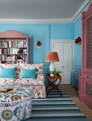 Unexpected touches of red in the lamps and upholstery make this pink and blue scheme in a country house by Nicola...